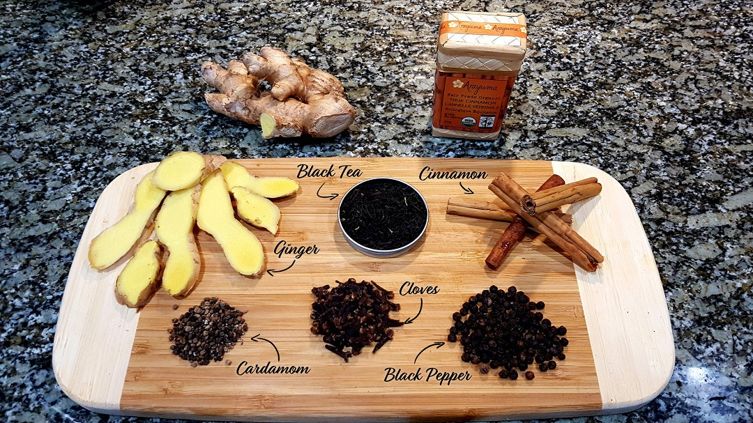 A wooden cutting board with whole spices for making chai tea