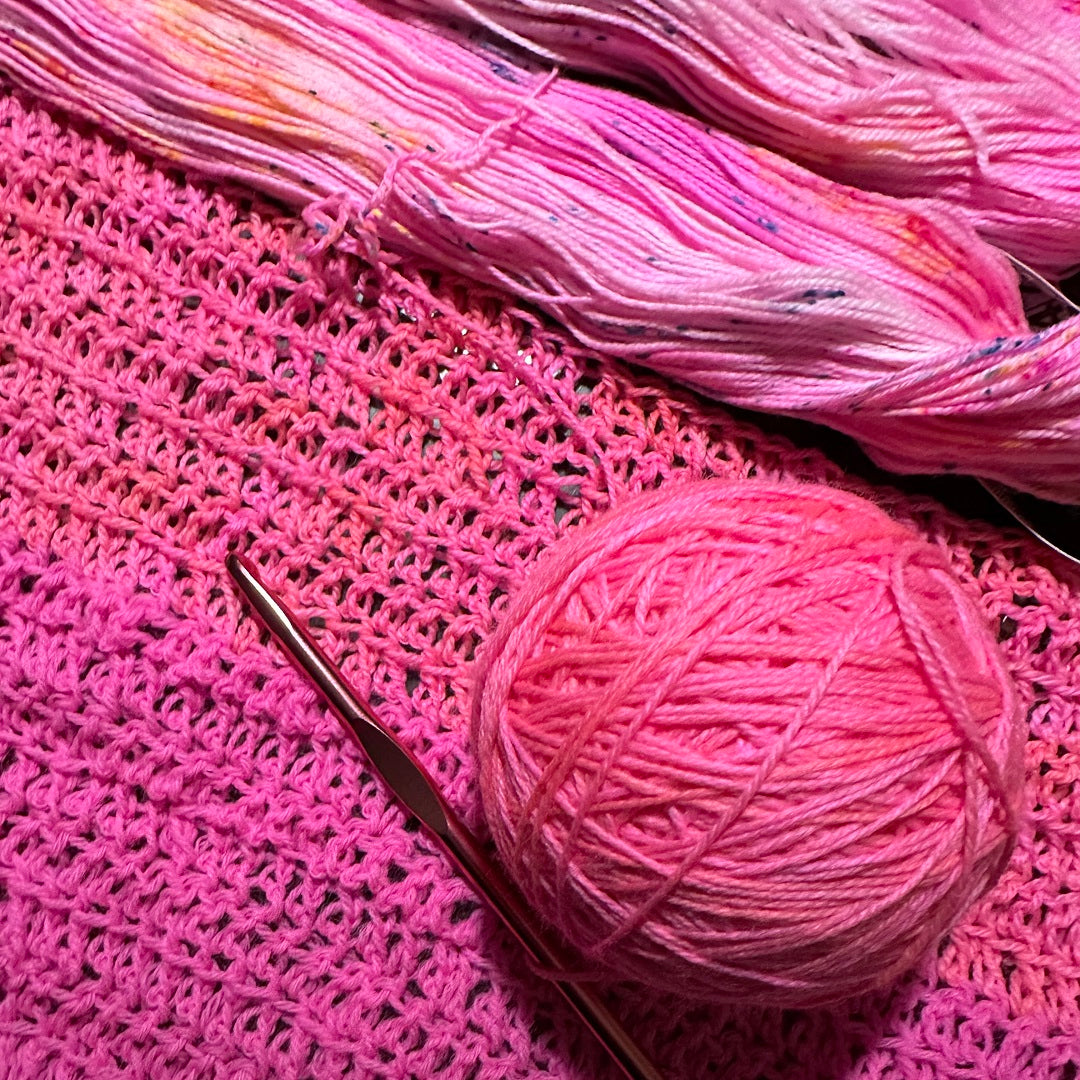 pink yarn crocheted into the start of a sweater