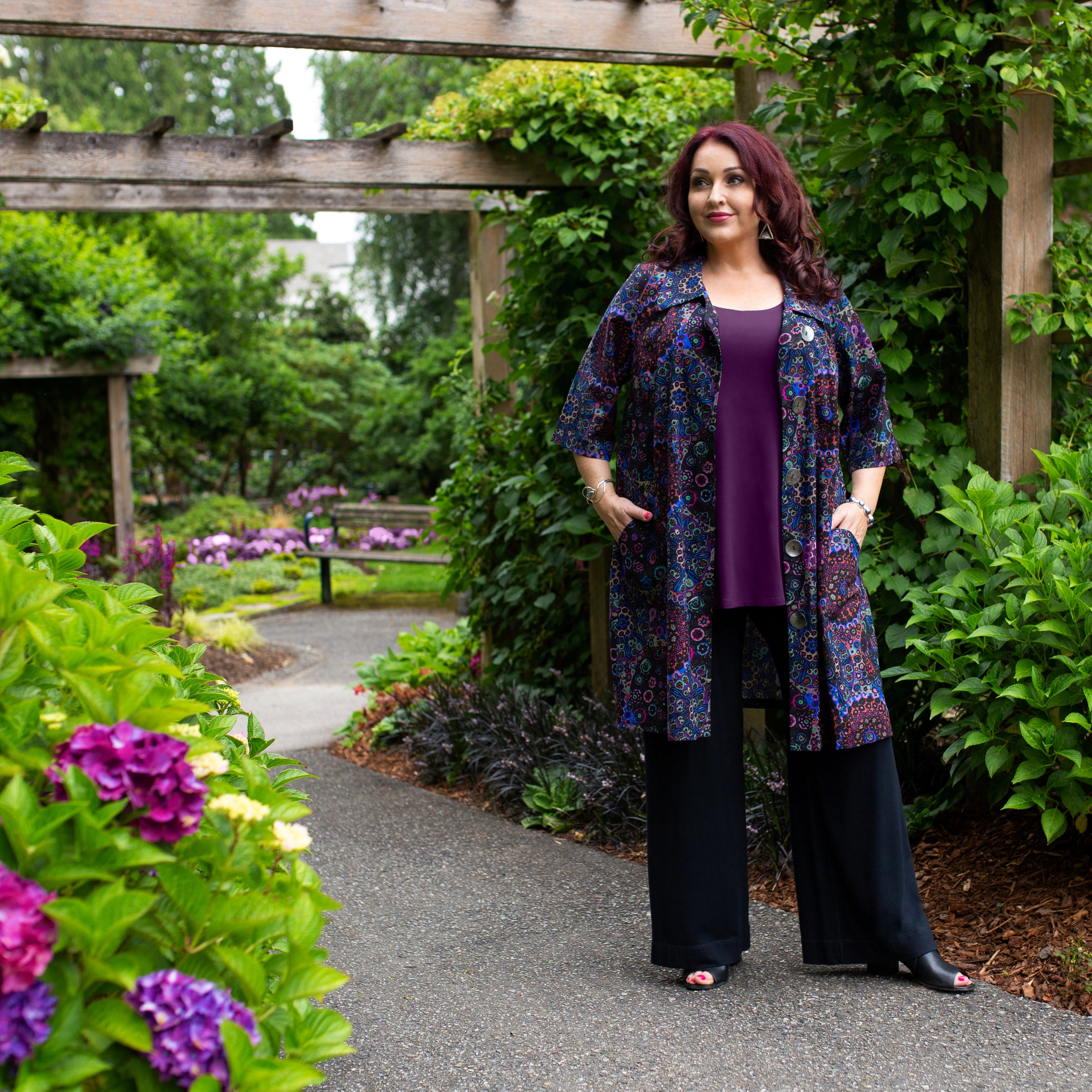 Diane Kennedy's Rhapsody coat styled over a purple tee tunic and black pants