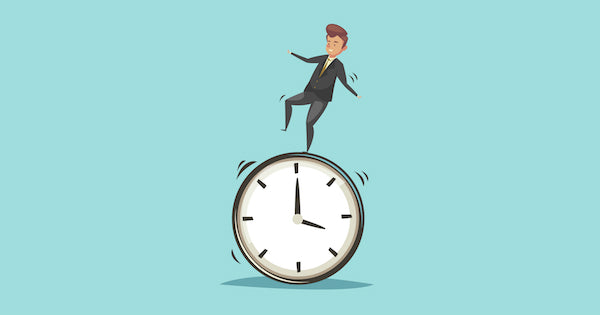 man balancing on top of a clock