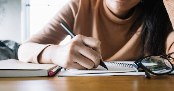 hand writing on a notebook