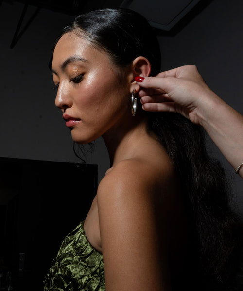 fashion model being styled at kabasia NYFW with delia langan jewelry earring