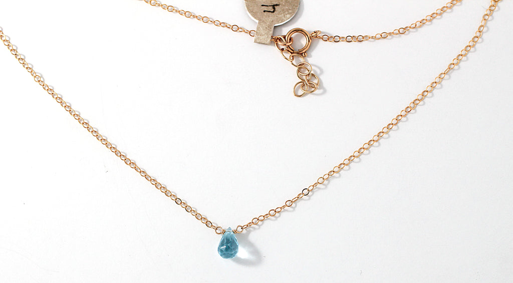 blue topaz and gold chain pendant by delia langan jewelry
