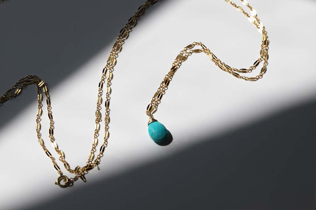 turquoise and gold necklace stilllife
