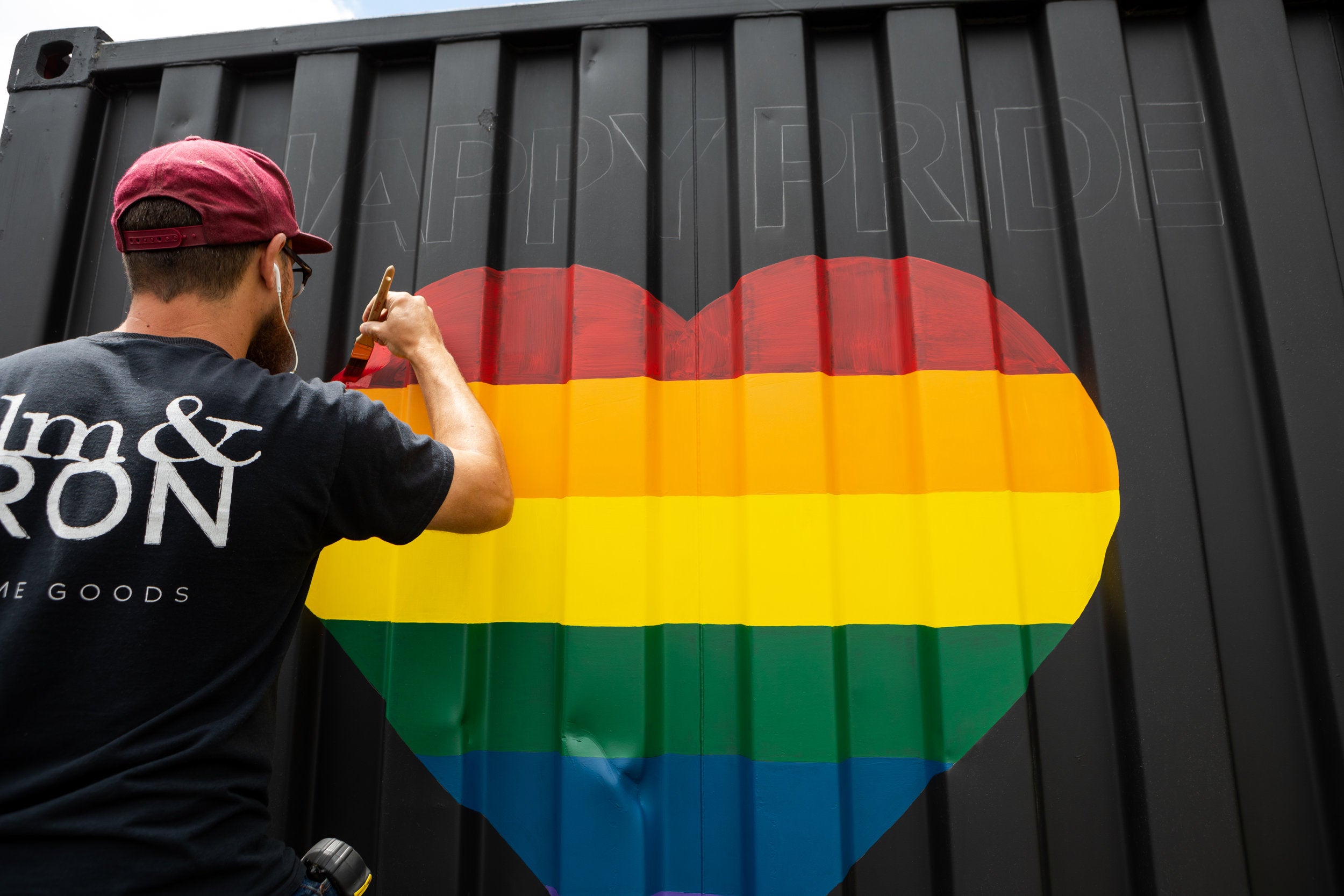 Tony, painting “Happy Pride” on one of our elm & IRON trailers.