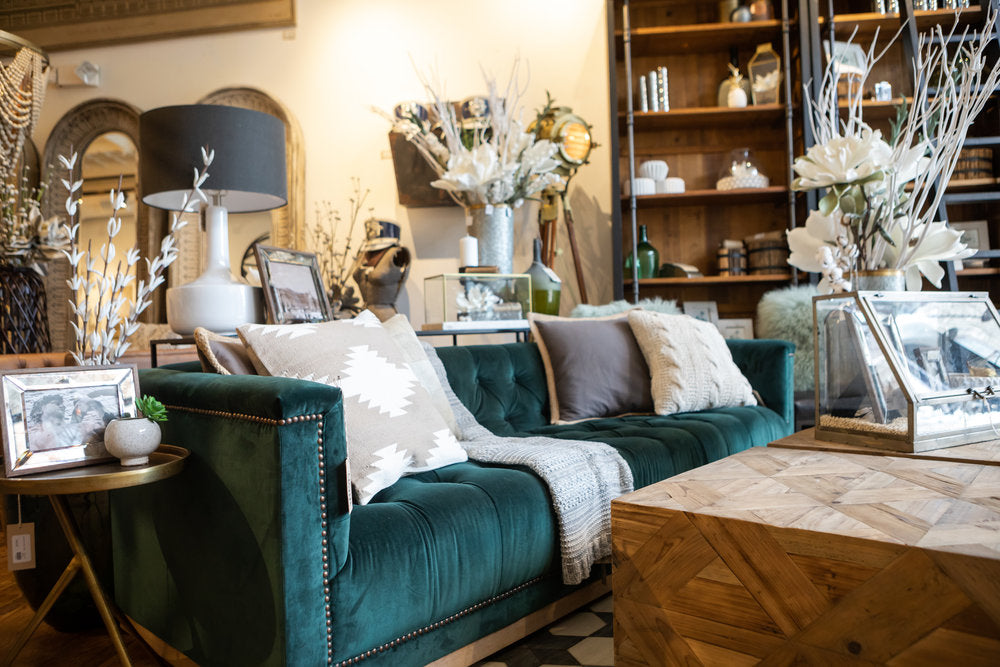Teal couch with neutral design pillows