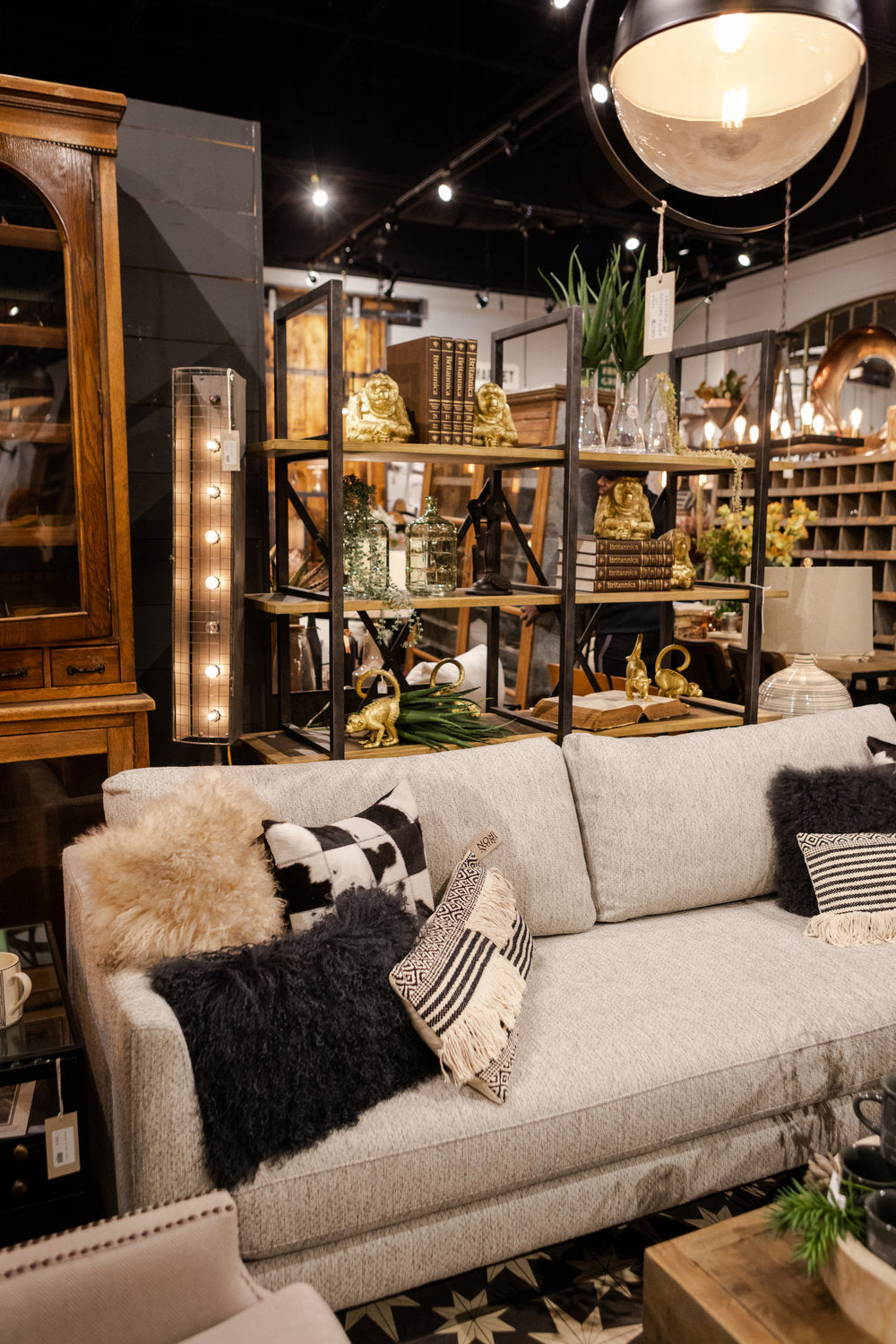 Grey couch with light and dark throw pillows