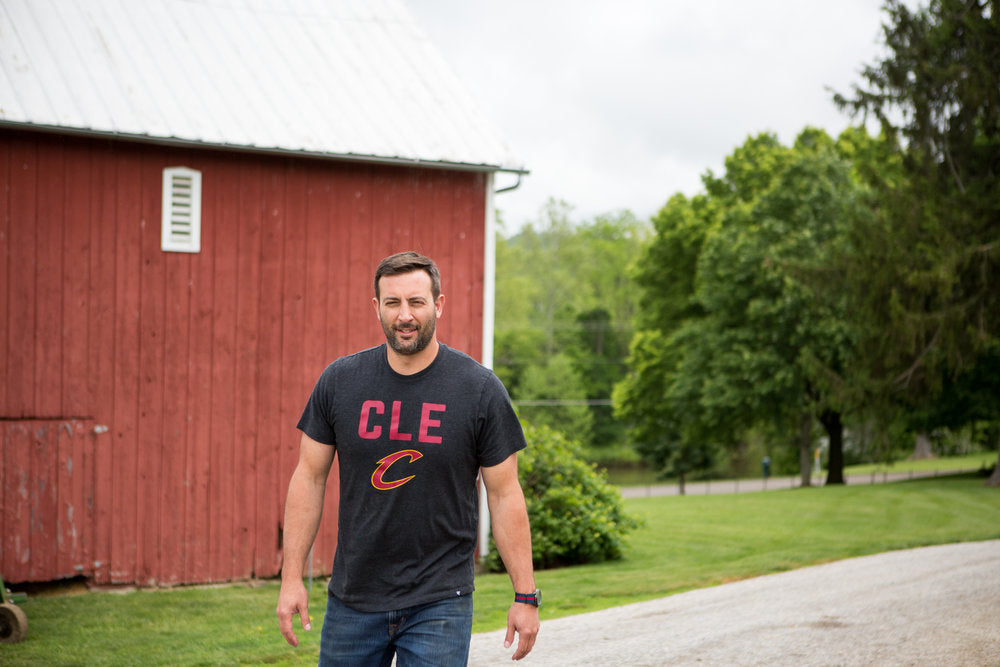 Daniel in front of a red barn