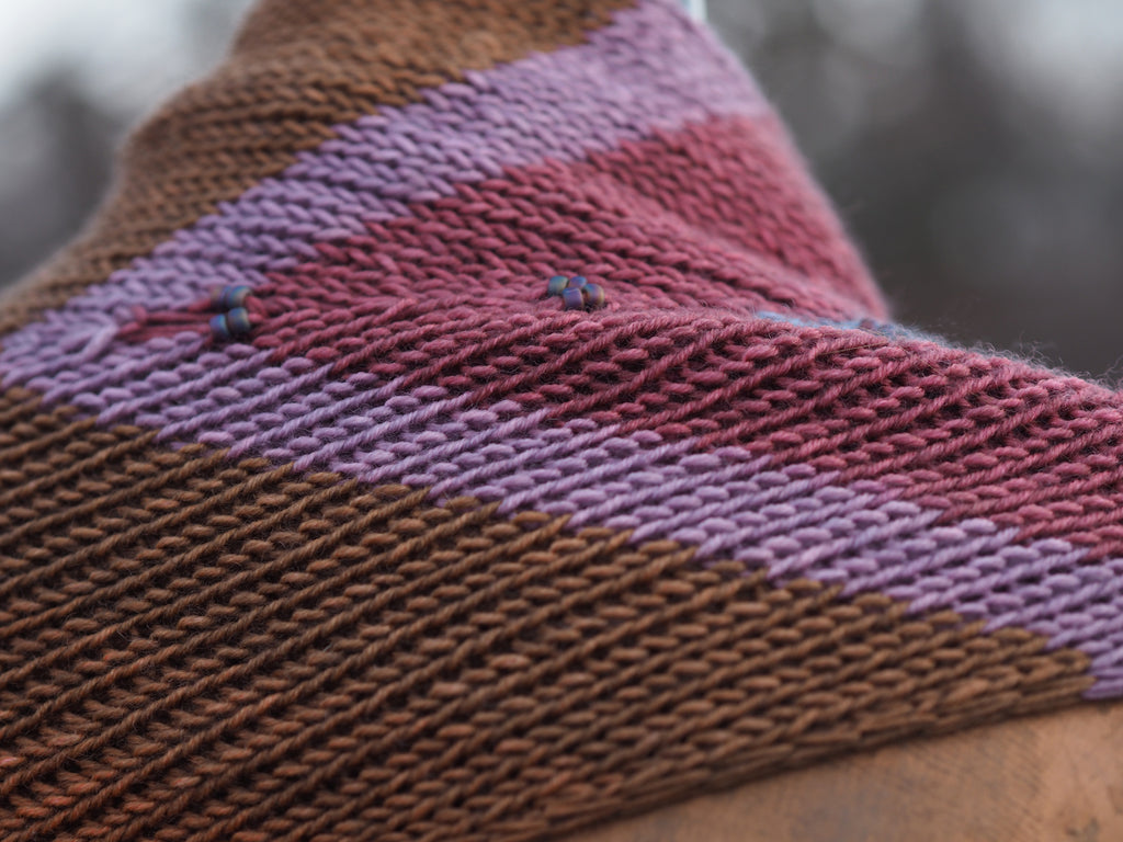 Flowsaic shawl poncho by Laura Nelkin | Tesserae self patterning yarn by Gauge Dye Works | striping striped knitting wool