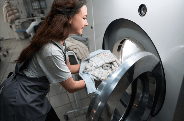 Hotel staff using state-of-the-art laundry equipment