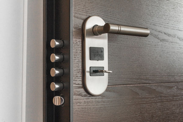 Close-up of a secondary lock on a hotel room door.