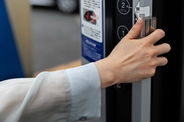 Guest using voice control features on a futuristic hotel safe.