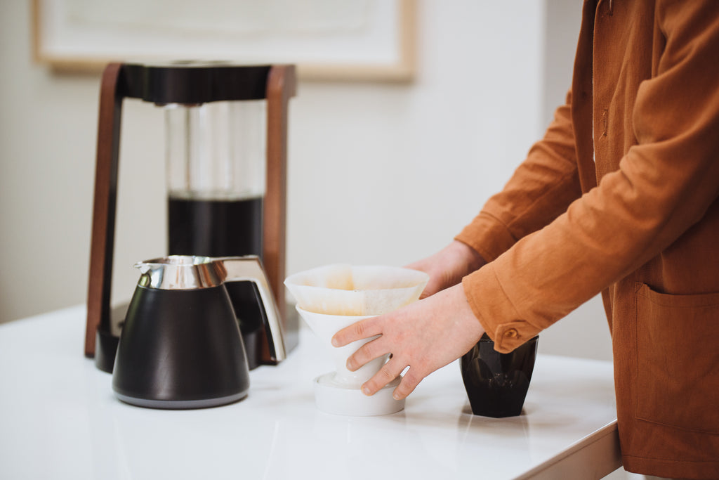 The Ratio Eight coffe machine in matte black with ceramic dripper, Chemex Paper filter, and Ratio Thermal Carafe.