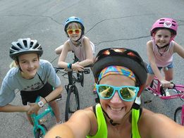 Woman biking with family