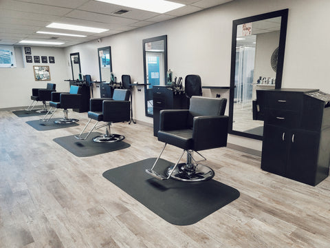 Empty hair salon with four chairs