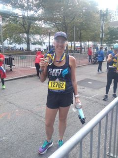 Woman at finish line with medal