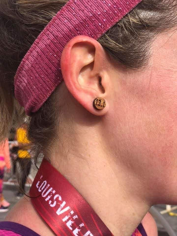 Close up of Ponya Bands Non-Slip Headband on woman, focusing on bourbon barrel earring