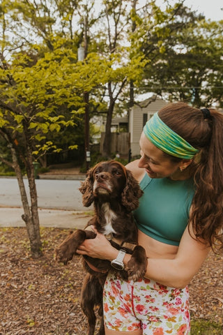 Katie in Ponya Bands Bamboo Terry Lined Sweatband with her dog Teddy