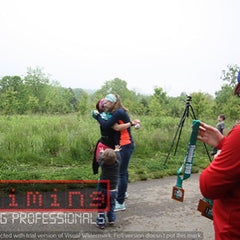 Two women in Ponya Bands' Bamboo Terry Lined Sweatbands hugging at end of race