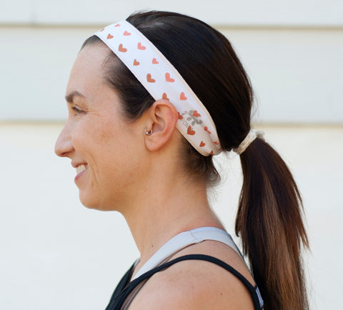 Woman in Ombre Hearts Ponya Bands Non-Slip Headband--profile view of left side