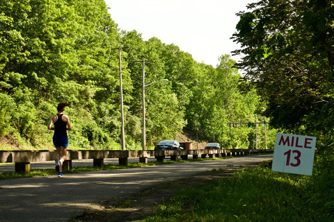 runner on race course from behind, crossing mile 13 in a Ponya Bands' Bamboo Terry Lined Sweatband