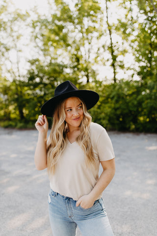 The Charlie Tee in Sand, styled with a wide brim fedora. 