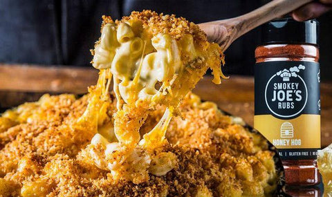 just-baked macaroni cheese with a spoon lifting it out of the dish