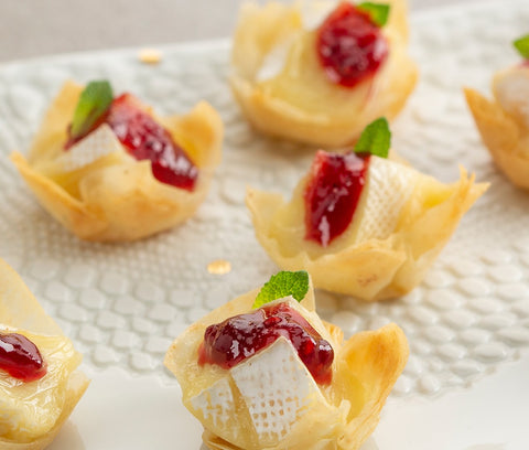 raspberry jam on top of brie cheese and filo pastry