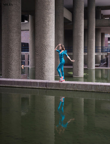 model wearing turquoise catsuit at barbican centre london