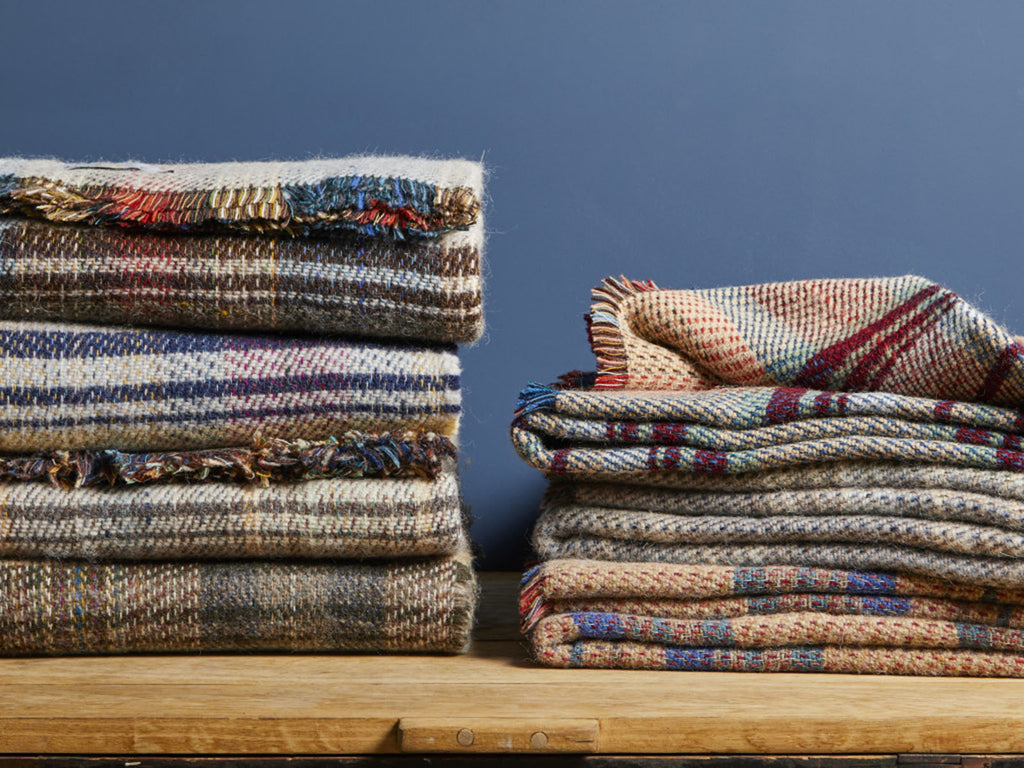 a stack of natural coloured recycled wool blankets