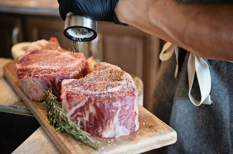 Meat on board being seasoned 