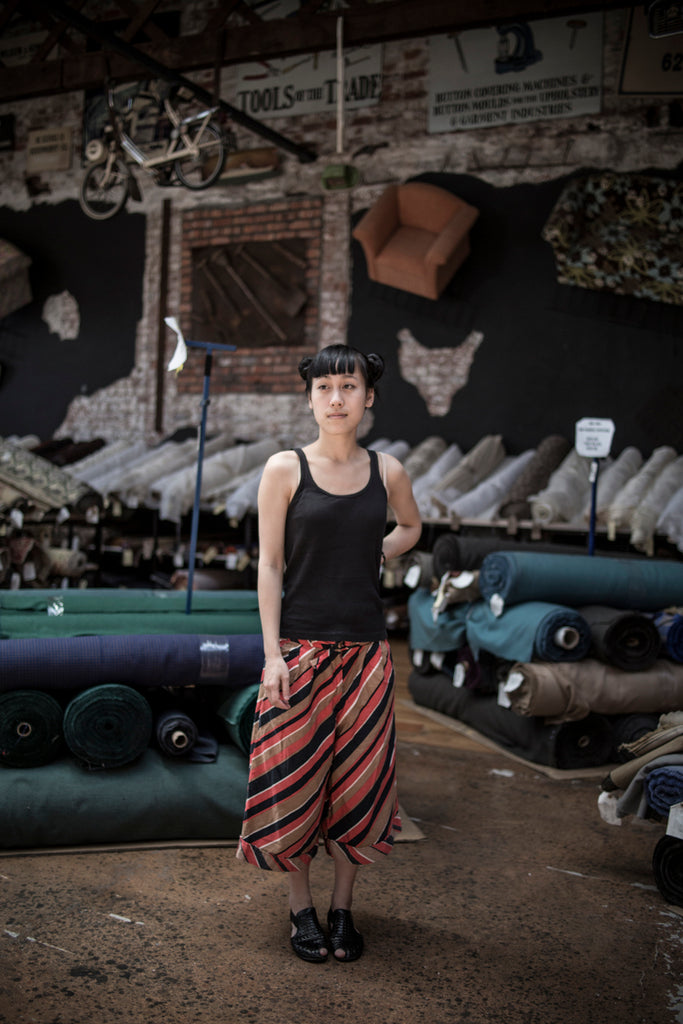 Portrait of Jenny Lai standing in upholstery fabric shop photo by Chris Saunders