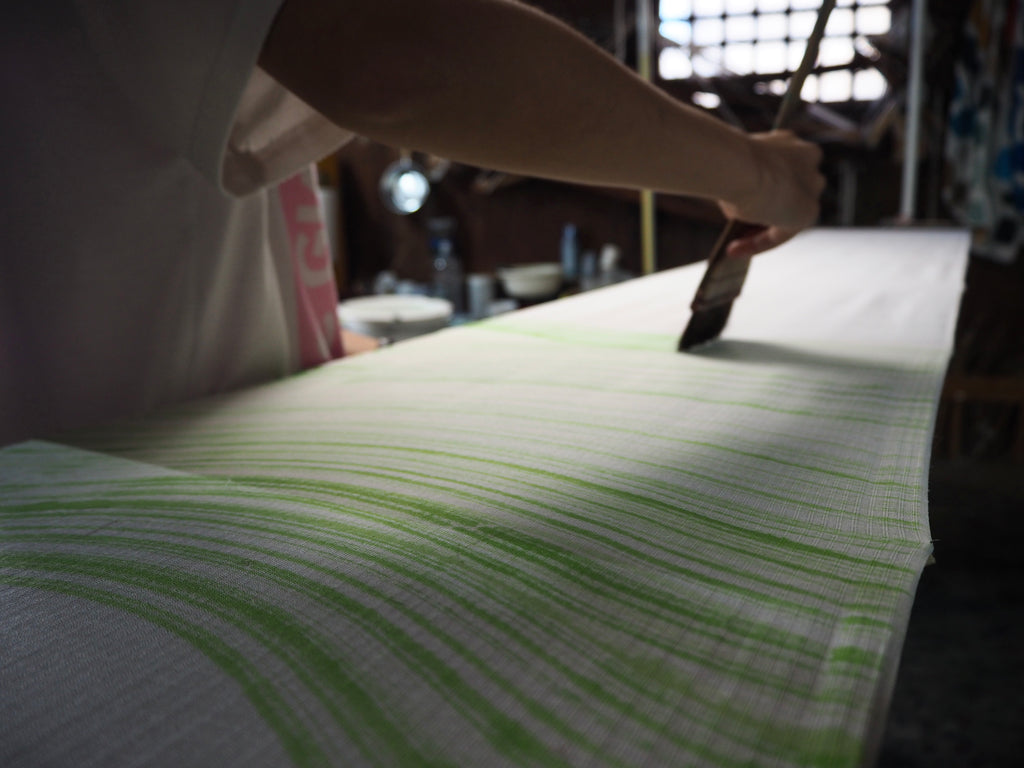 Jenny Lai applying first layer of color on floating fabric