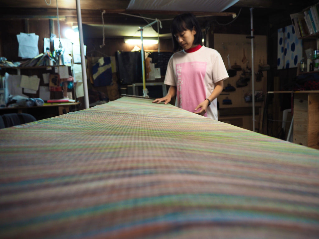 Jenny Lai inspecting final finished painted fabric