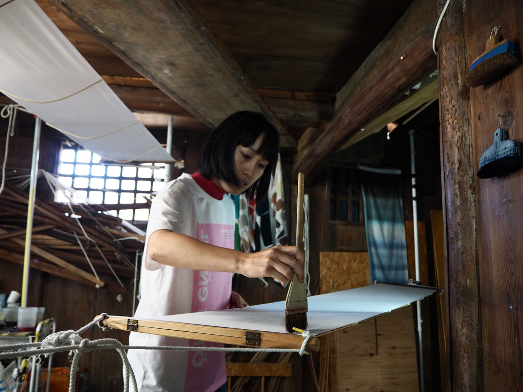 Jenny Lai painting dye on fabric with hikizome technique