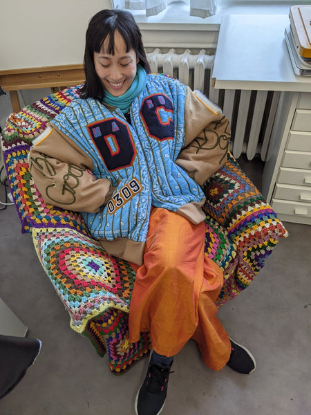 Jenny wearing a blue patchwork jacket by Dennis Chuene in his Berlin studio.