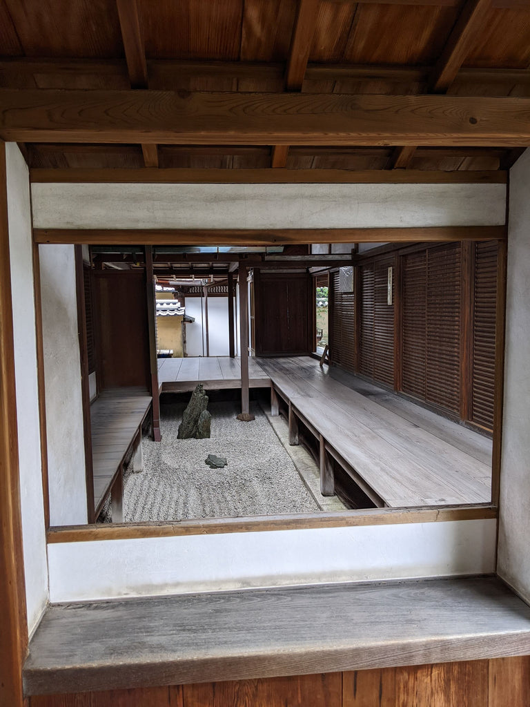 traditional wooden Japanese house with window into stone garden
