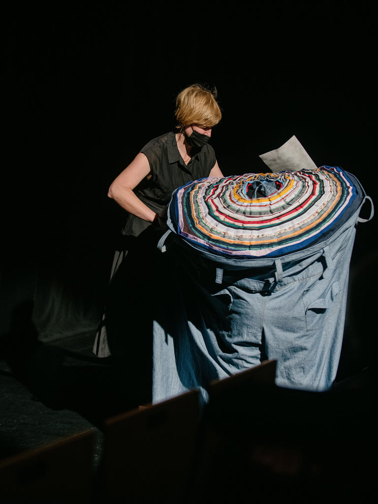 Woman ushers Giant Pant to their seat.