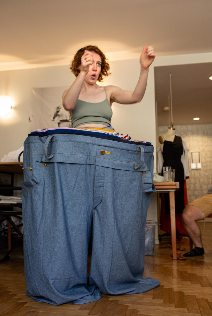 Mime actor in giant denim pant.