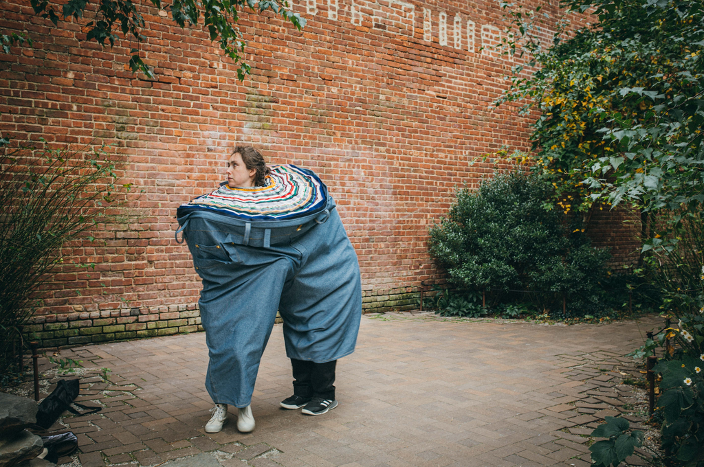 Actors playing in the giant denim pant at St. Ann's courtyard