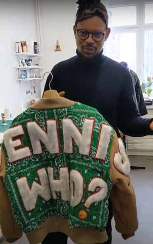 Dennis Chuene shows the back of his green patchwork jacket.