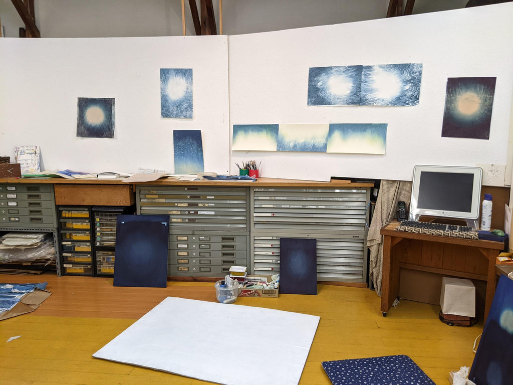 Printmaking studio of Sarah Brayer with white walls, filing cabinets, and artworks on walls