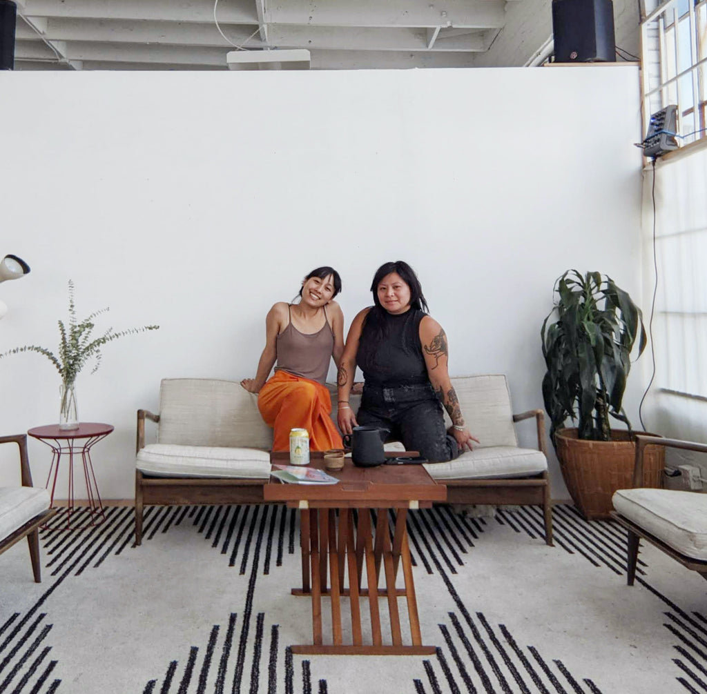 Jenny Lai and Lien Tong sit on sofa in Gem Studio Oakland.