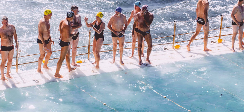 Swimmers of all ages enjoying an oceanfront pool