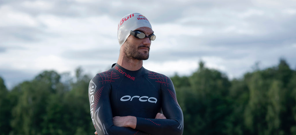 Richard Murray wearing a wetsuit and the FORM Smart Swim Goggles