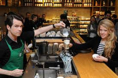 Starbucks Barista doing customer service in coffee shop