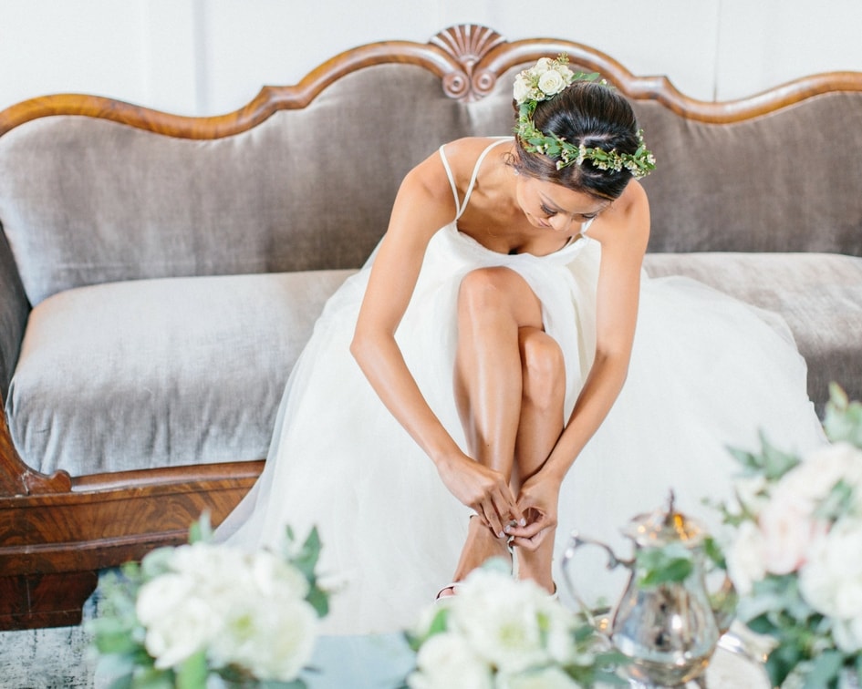 bride getting ready in wtoo wedding dress