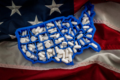  opioid epidemic and drug abuse concept with the map of USA filled with oxycodone and hydrocodone
