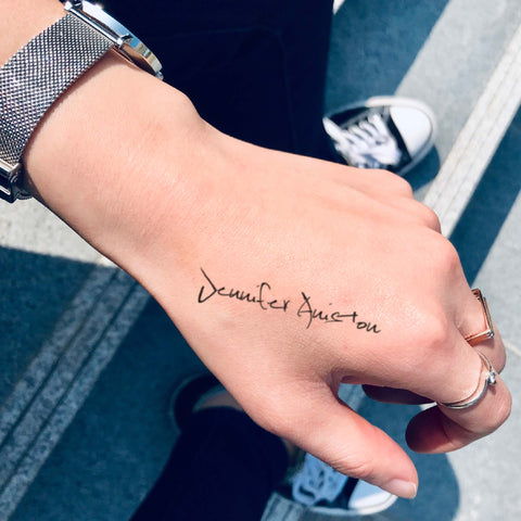 Jennifer Aniston custom temporary tattoo sticker design idea inspiration meanings removal arm wrist hand words font name signature calligraphy lyrics tour concert outfits merch accessory gift souvenir costumes wear dress up code