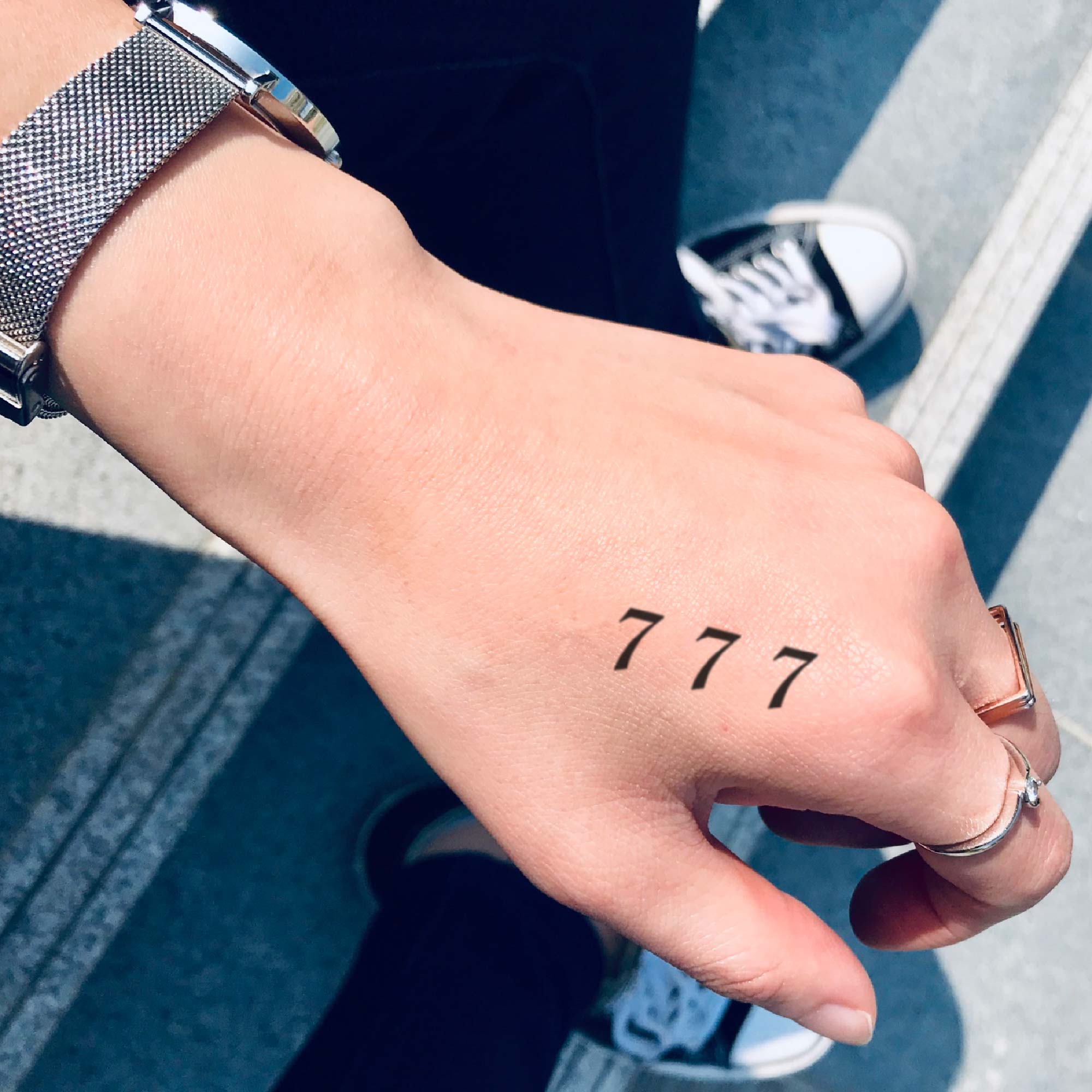 Lucky number 777 tattooed on the bicep